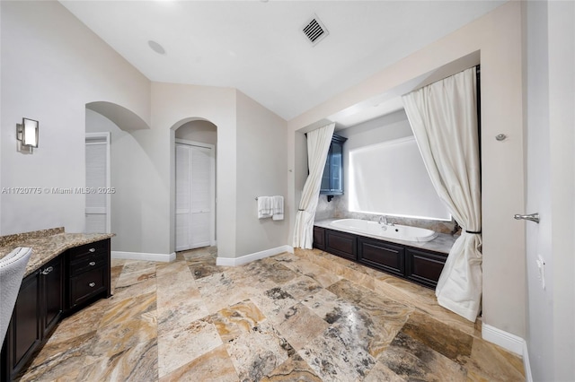 bathroom with a bathtub and vanity