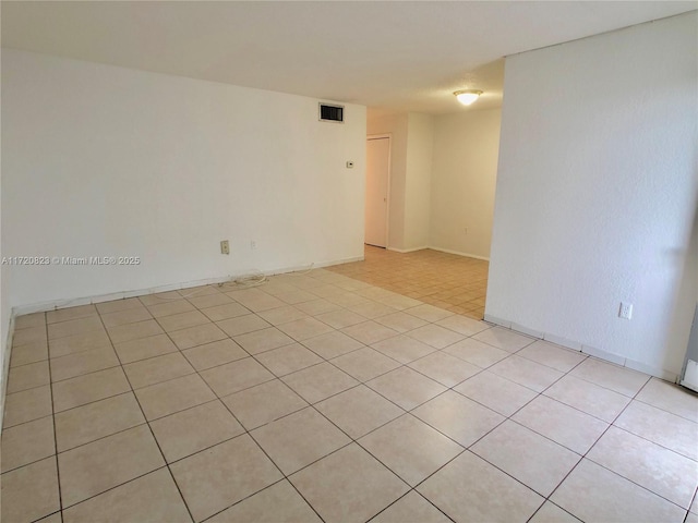 unfurnished room with light tile patterned floors