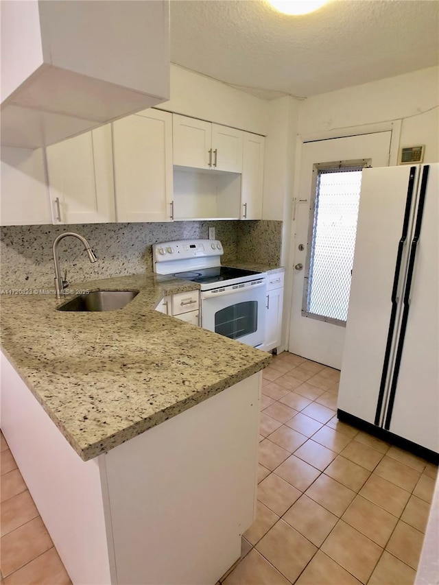 kitchen featuring light stone countertops, sink, white cabinets, and white appliances