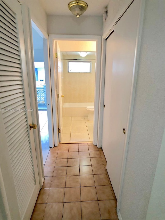 corridor with light tile patterned flooring