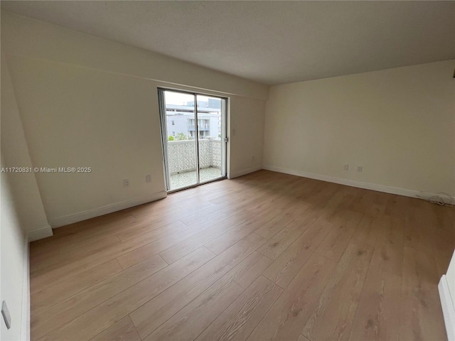 spare room with light hardwood / wood-style floors