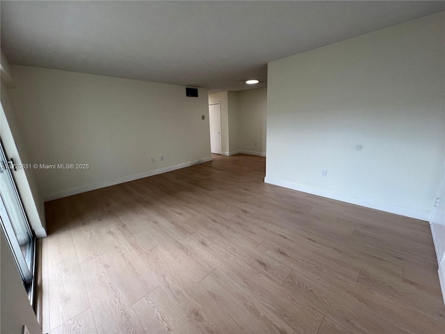 spare room featuring light hardwood / wood-style floors