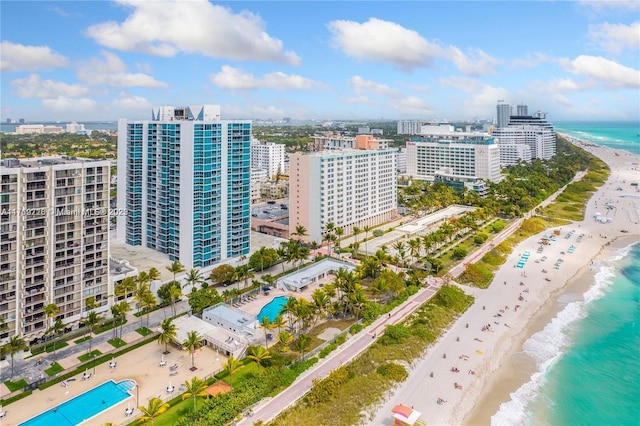 birds eye view of property with a water view and a view of the beach