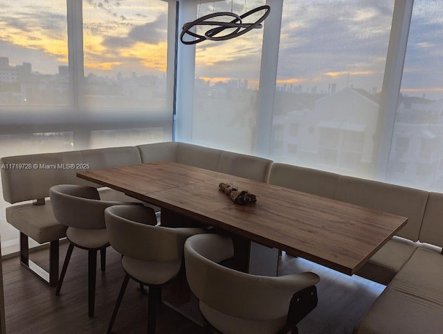 dining area with dark wood-type flooring and breakfast area