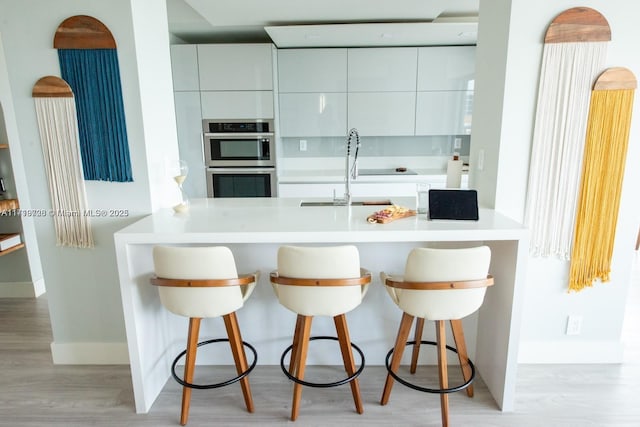 kitchen with a sink, a peninsula, and modern cabinets