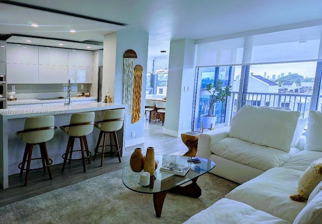 living room with a view of city and wood finished floors