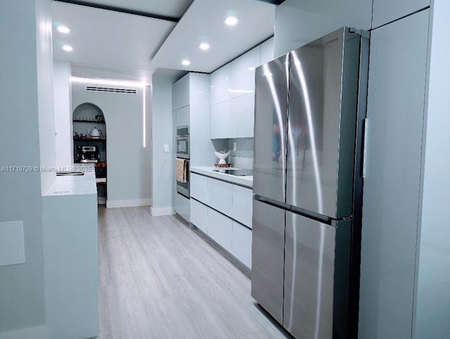 kitchen with light wood-style floors, modern cabinets, white cabinets, and freestanding refrigerator