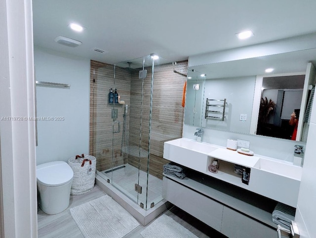 full bath featuring recessed lighting, toilet, a shower stall, and vanity