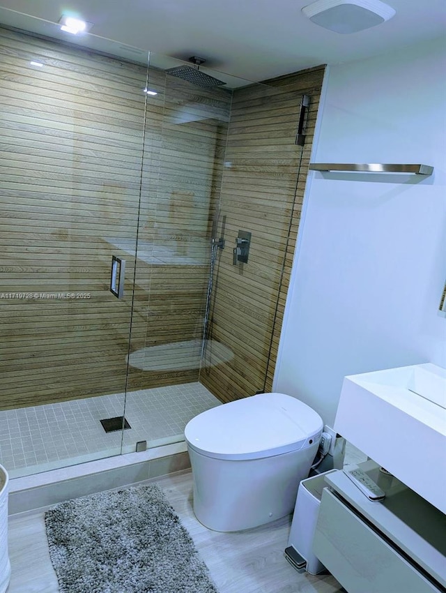 full bath featuring toilet, a stall shower, and vanity