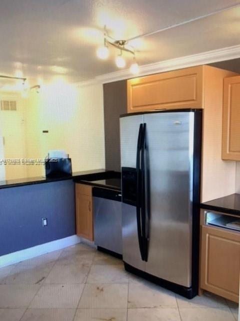 kitchen with crown molding, light tile patterned floors, and stainless steel appliances