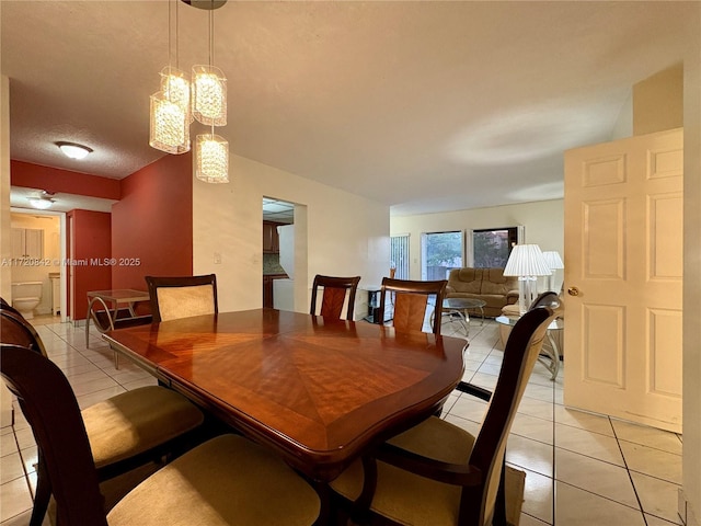 dining area featuring a textured ceiling and light tile patterned flooring