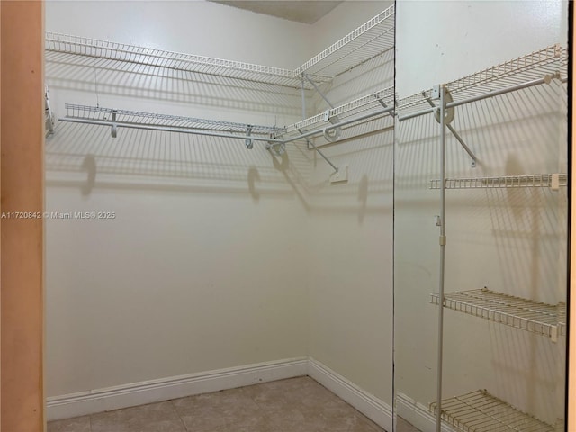 spacious closet featuring tile patterned floors