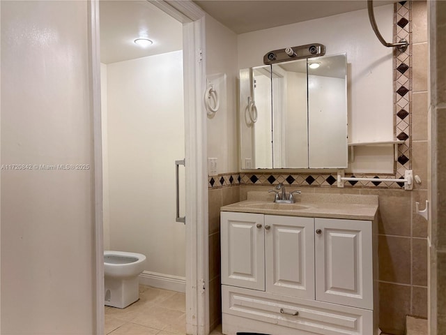 bathroom featuring tile patterned floors, vanity, tile walls, and toilet