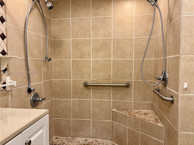 bathroom featuring vanity and a tile shower