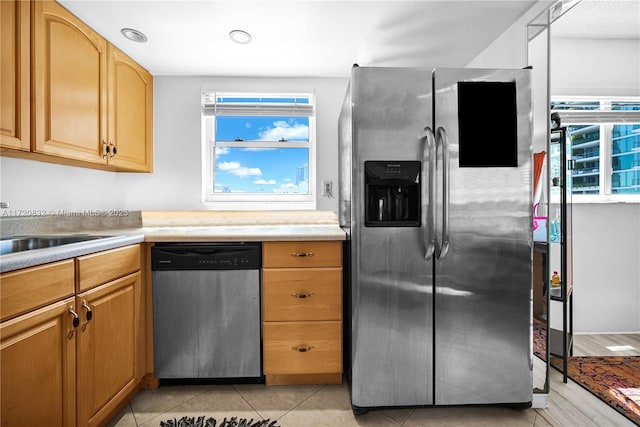 kitchen with light tile patterned floors and stainless steel appliances