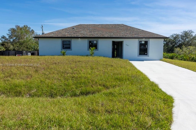 ranch-style home with a front lawn