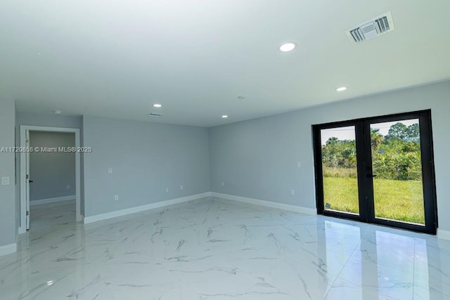 spare room featuring french doors