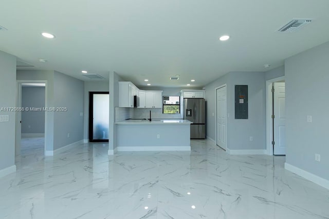 unfurnished living room with electric panel and sink