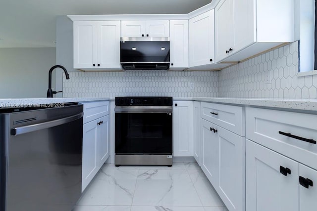 kitchen featuring light stone countertops, tasteful backsplash, stainless steel appliances, sink, and white cabinets