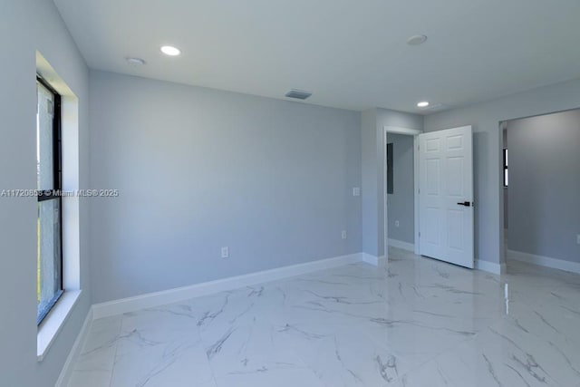 unfurnished room featuring a wealth of natural light