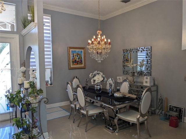 dining space with tile patterned floors, ornamental molding, and an inviting chandelier