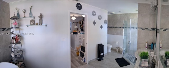 bathroom featuring tile patterned floors, toilet, and walk in shower