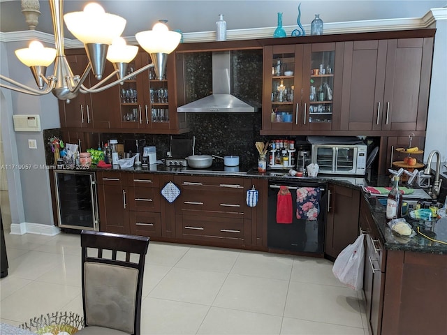 kitchen with wall chimney exhaust hood, hanging light fixtures, wine cooler, backsplash, and dark stone countertops