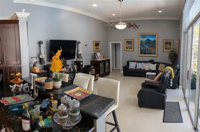 dining space with ceiling fan, ornamental molding, and light tile patterned flooring