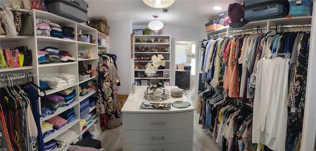 walk in closet featuring light hardwood / wood-style flooring