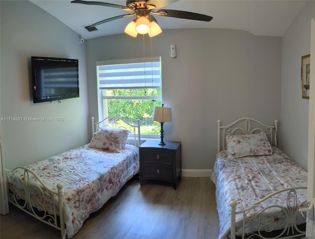 bedroom featuring ceiling fan, vaulted ceiling, and hardwood / wood-style flooring