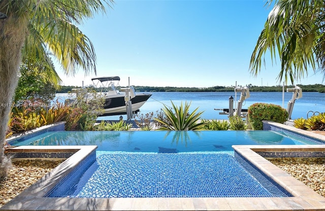 view of swimming pool with a water view and a dock