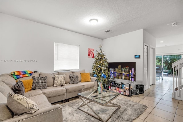 tiled living room with a textured ceiling