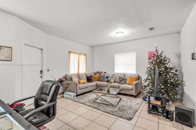 tiled living room with a textured ceiling