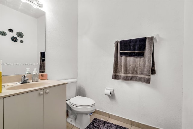 bathroom featuring toilet, vanity, and tile patterned floors