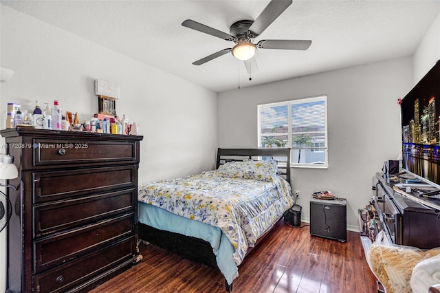 bedroom with ceiling fan and dark wood-type flooring