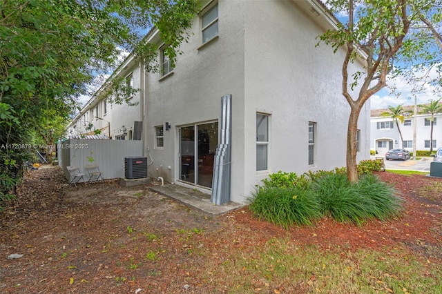 rear view of house with central air condition unit