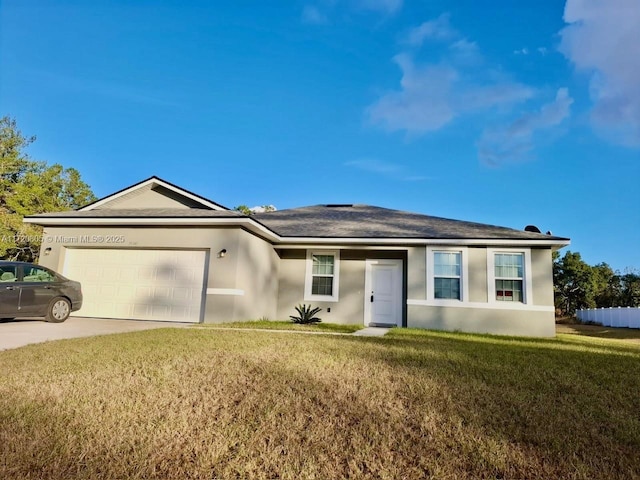 single story home featuring a garage and a front lawn