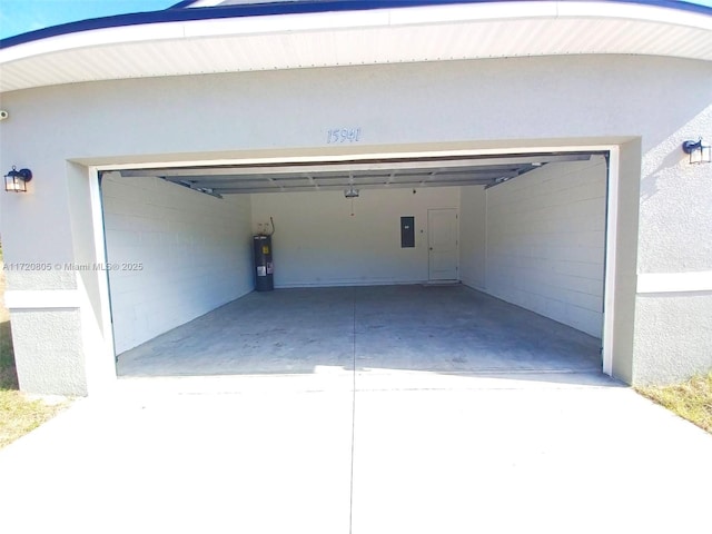 garage featuring electric panel, electric water heater, and a carport