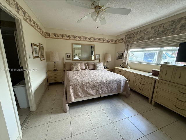 tiled bedroom featuring ceiling fan and a textured ceiling