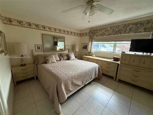 tiled bedroom featuring ceiling fan and a textured ceiling