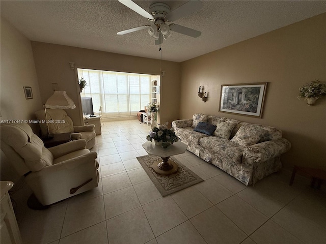 tiled living room featuring a textured ceiling and ceiling fan