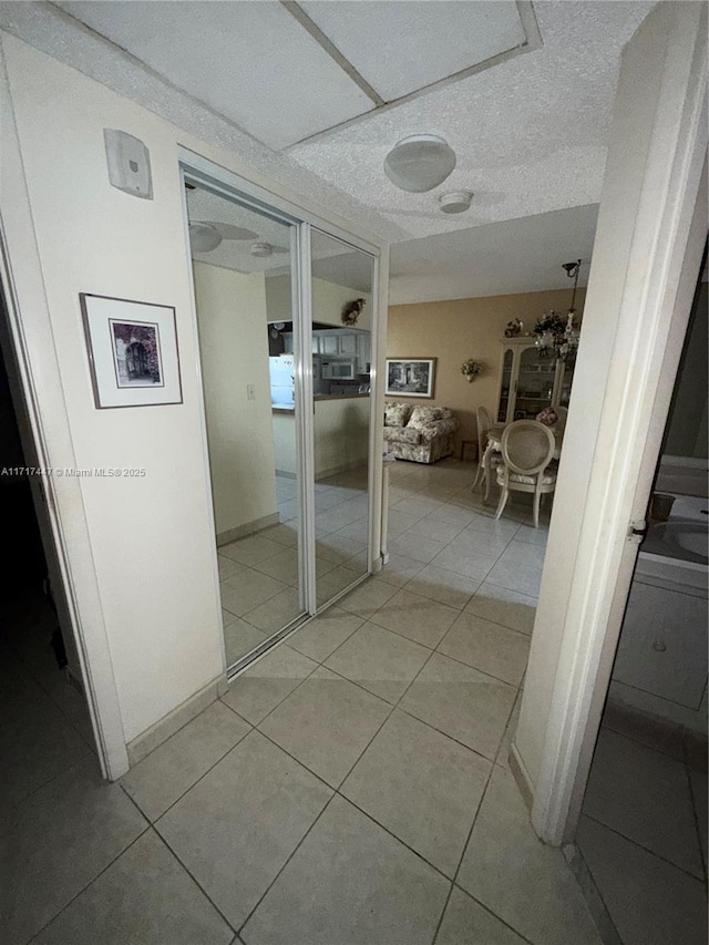 hall with light tile patterned floors