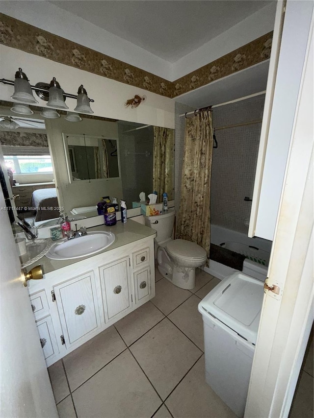 bathroom with toilet, a shower with curtain, vanity, and tile patterned floors