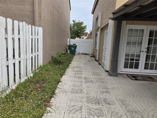 view of side of property with french doors and a patio area