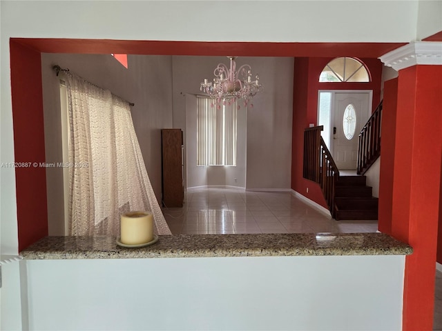 interior space with an inviting chandelier and tile patterned floors