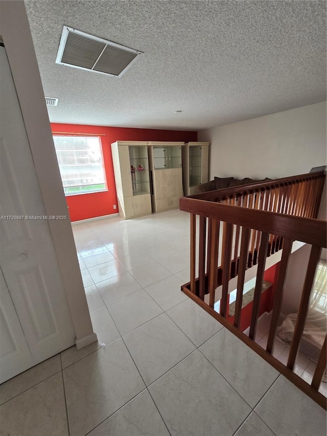 corridor featuring light tile patterned floors