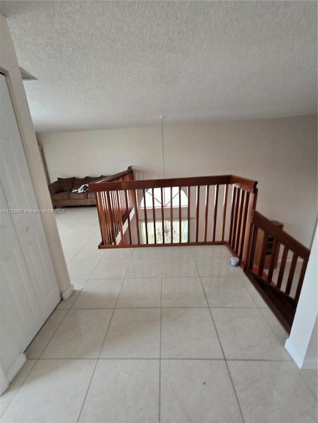 corridor featuring light tile patterned floors