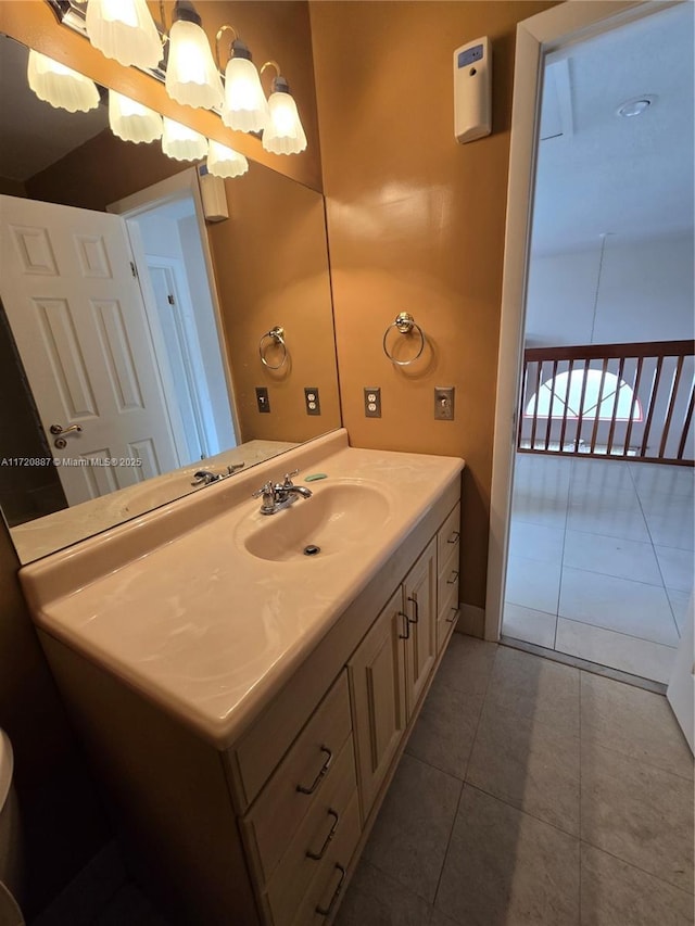 bathroom with vanity, tile patterned flooring, and a notable chandelier