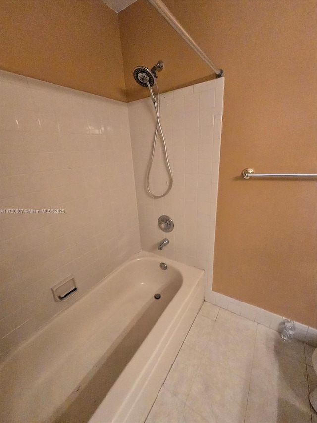 bathroom with tiled shower / bath and tile patterned flooring