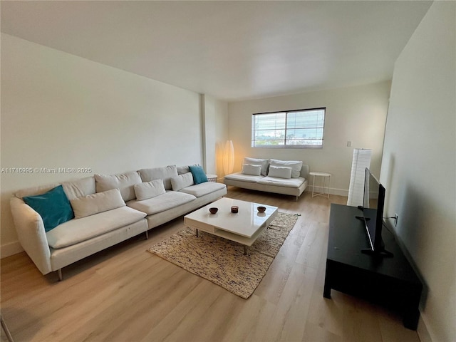 living room with light wood-style flooring and baseboards